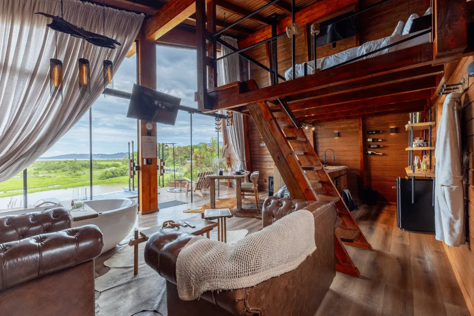 Cabana Brasa living room with a tub and stairs up to the loft
