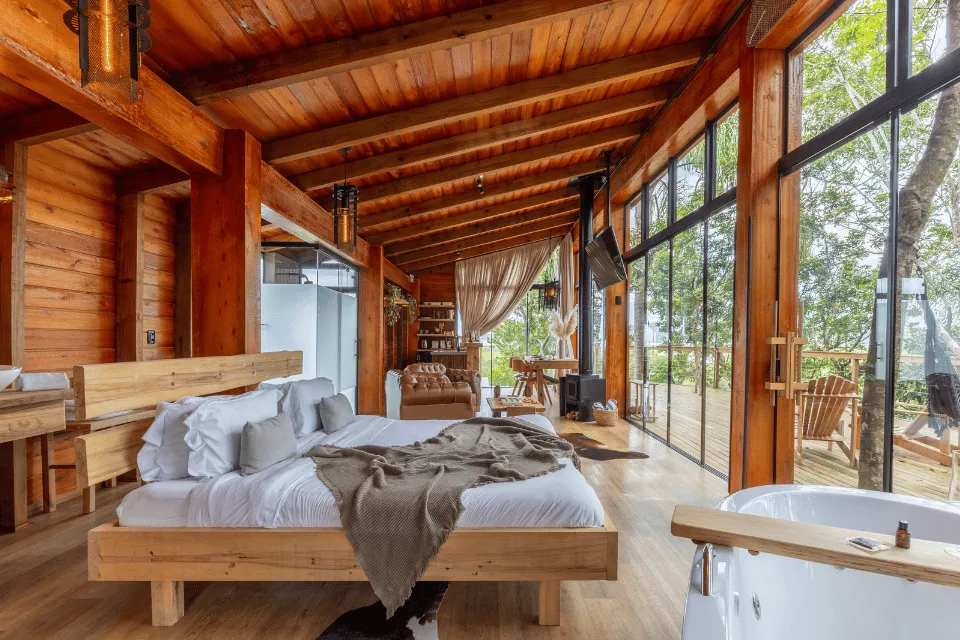 Cabana Brisa suite with a tub and a glass wall facing the woods